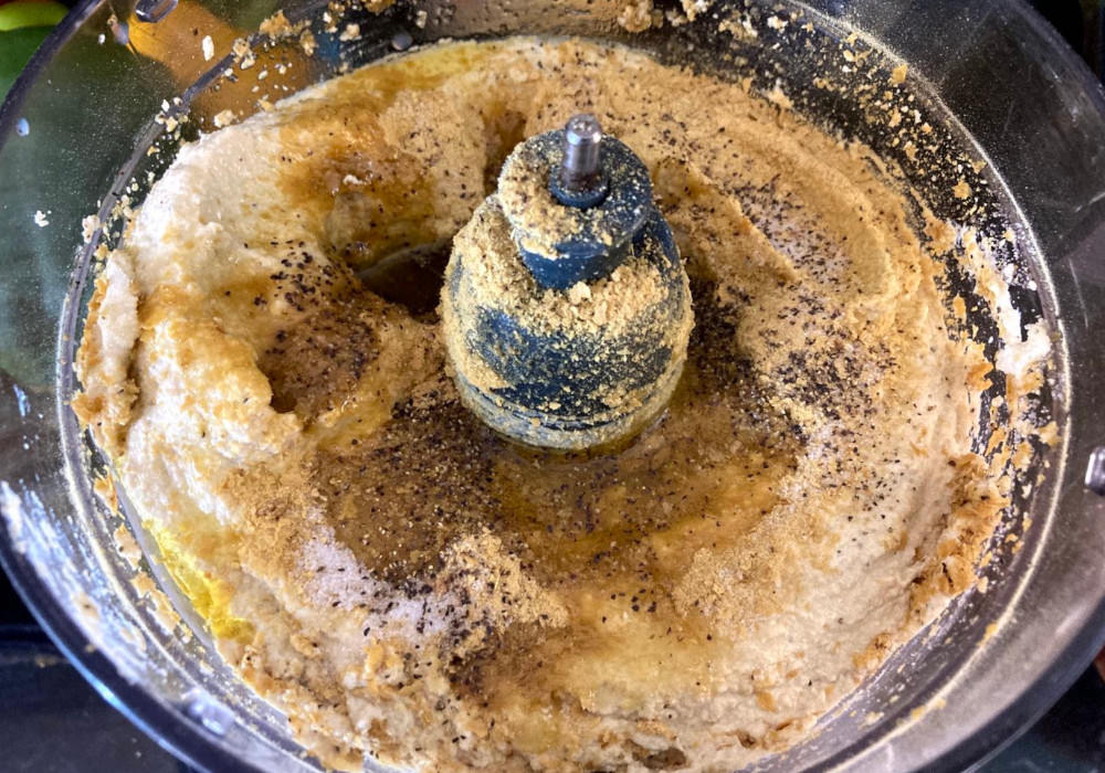 Making tofu ricotta in a food processor, with tofu, nutritional yeast, black pepper, salt and olive oil.