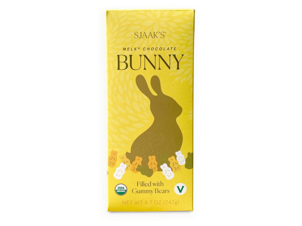 Sjaak's brand yellow packaging for vegan milk chocolate easter bunny with gummy bears inside.