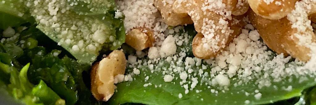 Banner of vegan pesto ingredients: walnuts, basil and vegan parmesan.