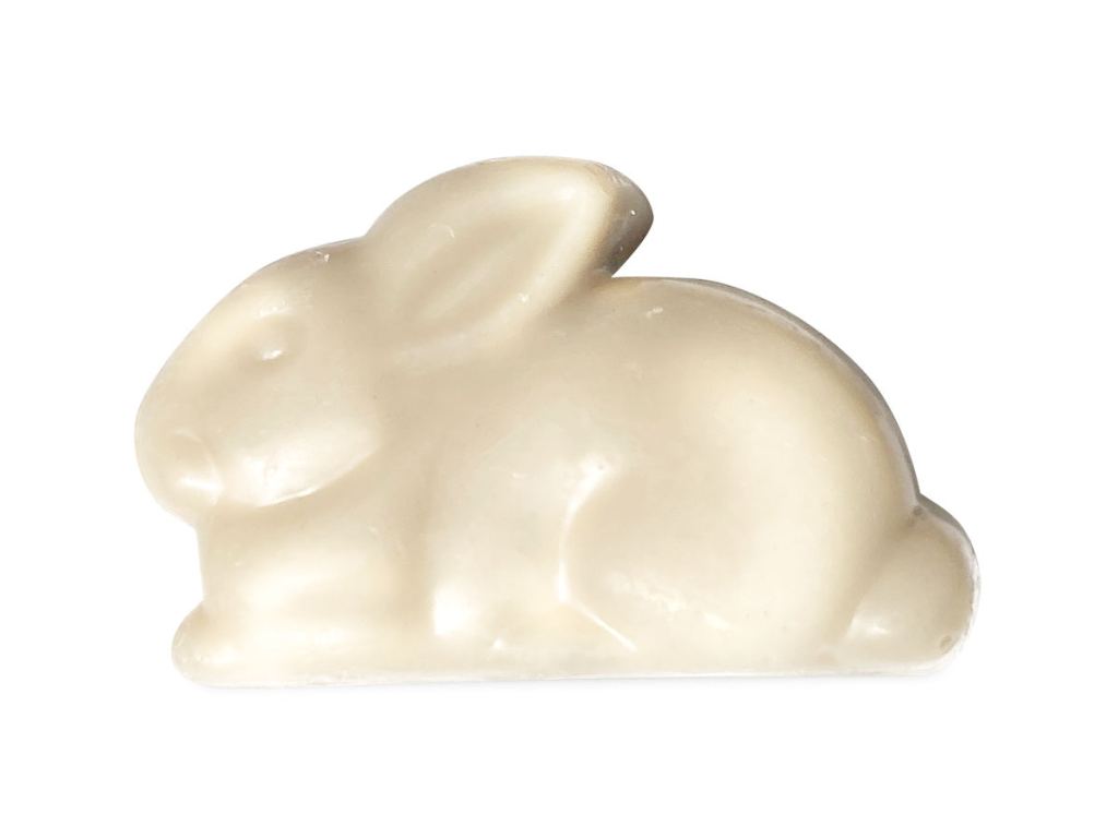 Sjaak's vegan white chocolate bunny laying down with ears back, perfect vegan easter candy.