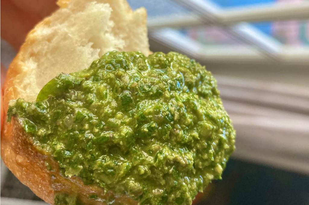 Fresh vegan pesto on a piece of Italian bread.